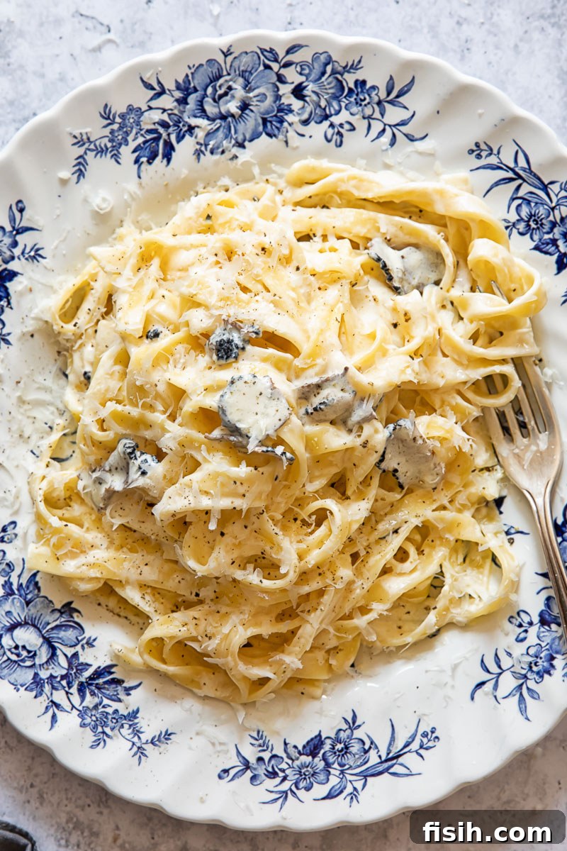Creamy Truffle Tagliatelle 2 Top down view of tagliatelle pasta with truffle sauce on a plate