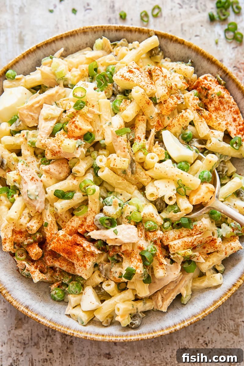 An overhead shot showcasing a generous portion of Tuna Macaroni Salad in a large serving bowl, highlighting its vibrant colors and inviting texture.
