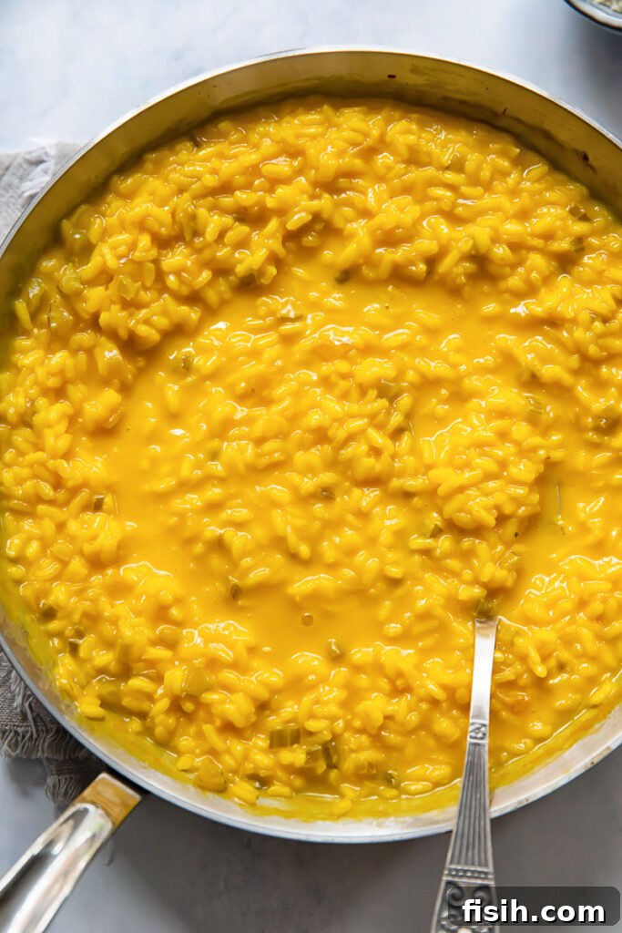 Liquid Gold Saffron Risotto 2 top down view of a pan of yellow saffron risotto