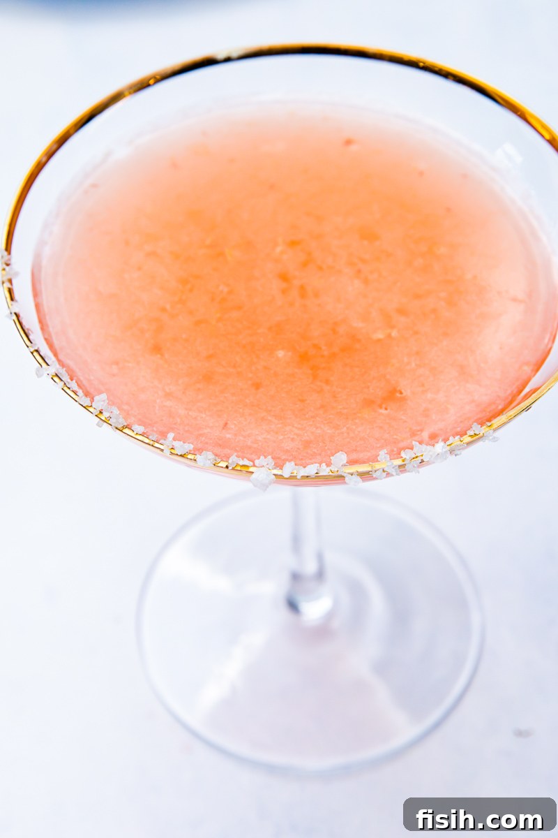 Top down view of blood orange margarita in a salt rimmed glass
