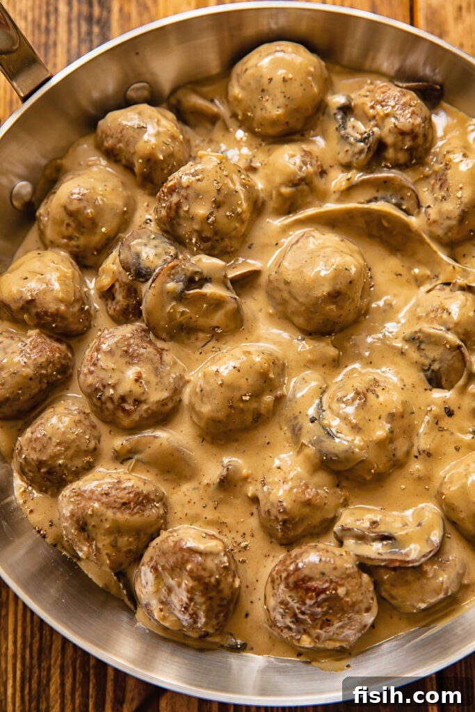 Top down view of meatballs in Marsala sauce in a pan