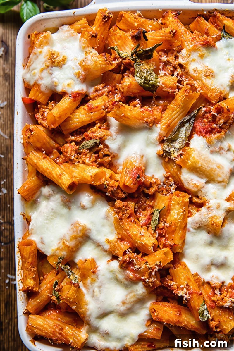 Top down view of pasta al forno with melted cheese in a baking dish