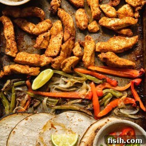 Top down view of tortillas and fajita toppings on a baking sheet