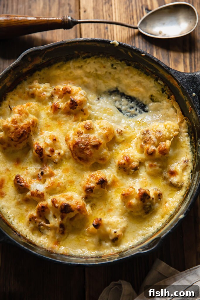 Close up shot of cauliflower florets in a pan with Mornay sauce