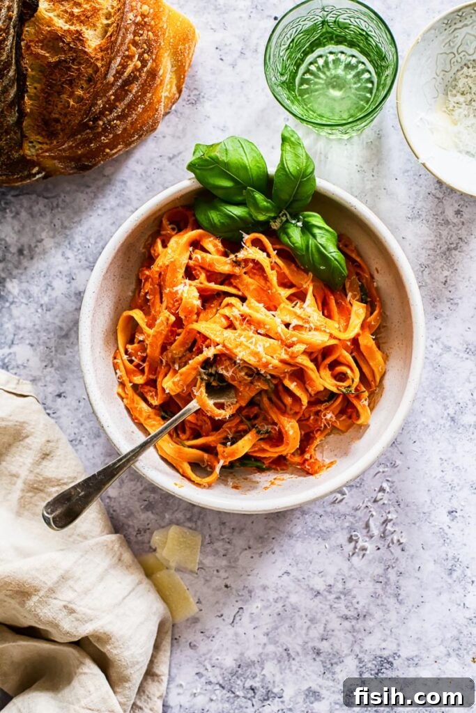 A perfectly portioned bowl of creamy pasta, highlighting the sauce's texture and minimal garnish.