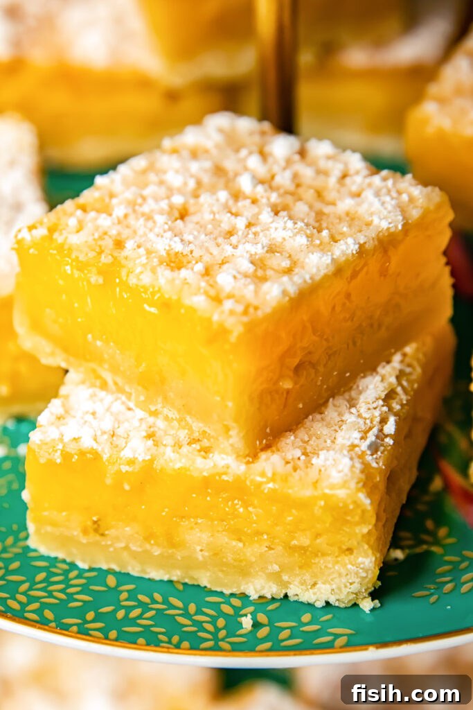 Zesty Lemon Delights 2 Close up shot of stacked lemon bars on a platter
