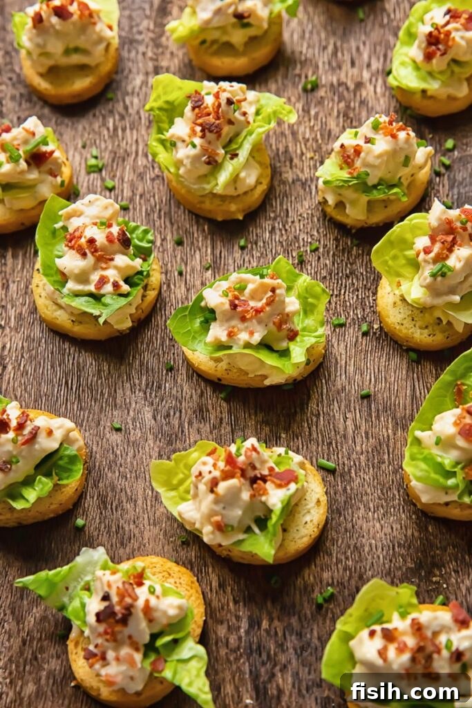 Crispy Caesar Chicken Bites 4 Close-up of elegantly arranged Chicken Caesar Crostini on a rustic cutting board, highlighting the fresh ingredients and inviting presentation.
