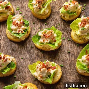 Crispy Caesar Chicken Bites 6 Close-up of many chicken Caesar crostinis laid next to each other on a cutting board