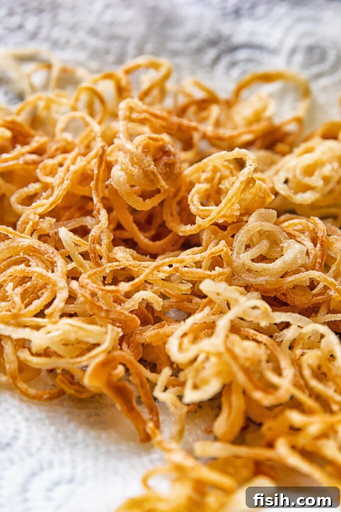 Close up shot of crispy caramelised onions stacked on top of each other on a towel