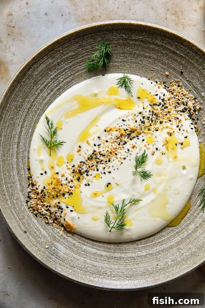 Whipped feta on a plate with topping and dill