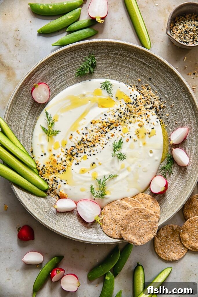 A plate of the dip with assortment of vegetables and crackers