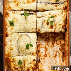 Wholesome Plant-Based Lentil Moussaka 7 Vegetarian moussaka in a baking dish with pieces removed