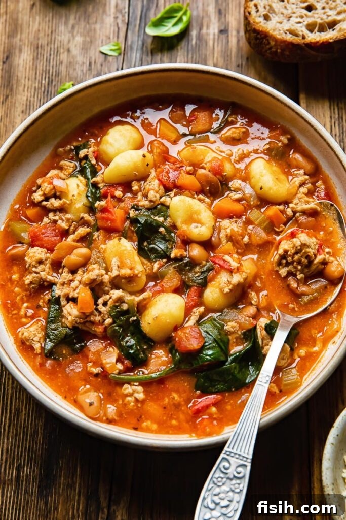Nduja-Infused Sausage Gnocchi Soup 5 bowl of sausage gnocchi soup with a spoon