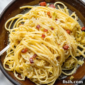 Top-down view of a plate of linguine pasta with creamy leeks and pancetta.