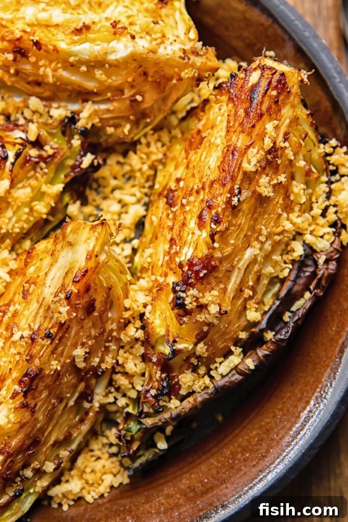 close up of miso butter roasted cabbage wedges on a plate