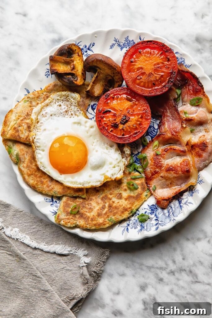 Top down shot of Irish potato farls on a plate served with bacon and eggs
