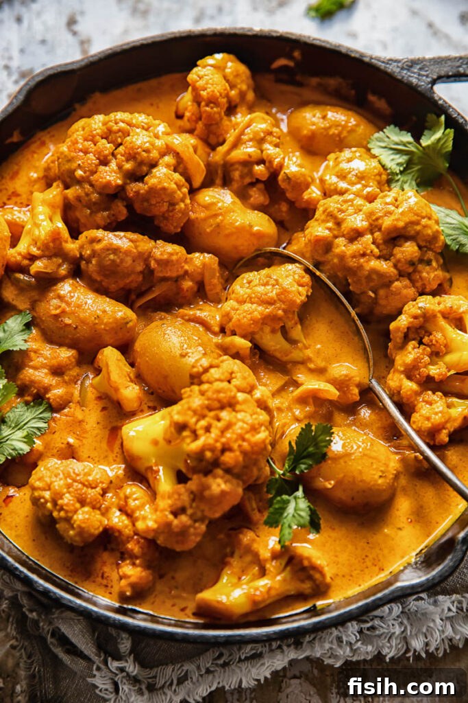 cast iron pan with potato cauliflower tikka masala