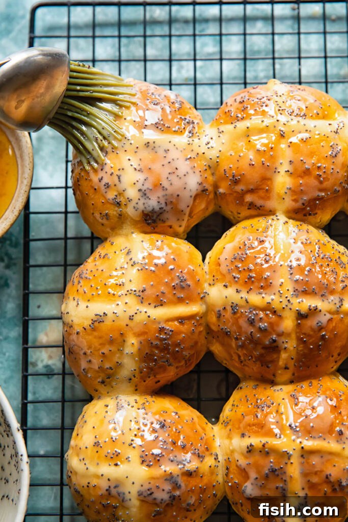 Sunshine Lemon Poppy Seed Hot Cross Buns 4 A kitchen brush gently applies the lustrous lemon poppyseed glaze to the freshly baked hot cross buns, creating a beautiful sheen and locking in flavor.