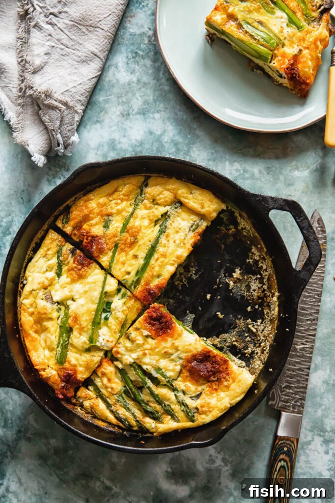 Vegetable frittata with a quarter slice removed, showing its fluffy texture