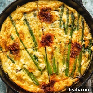 Vegetable frittata in a cast iron pan cut into quarters