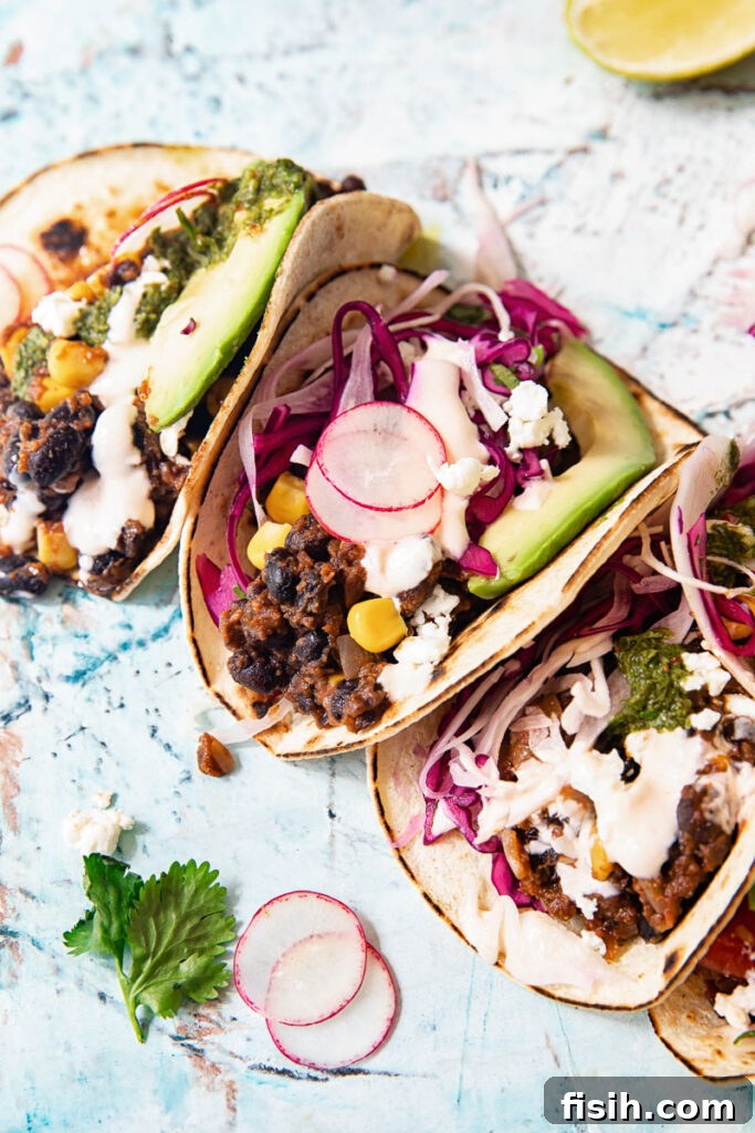 Black Bean Corn Tacos Topped with Zesty Cilantro Lime Slaw 2 Black bean tacos half folded with cilantro lime slaw