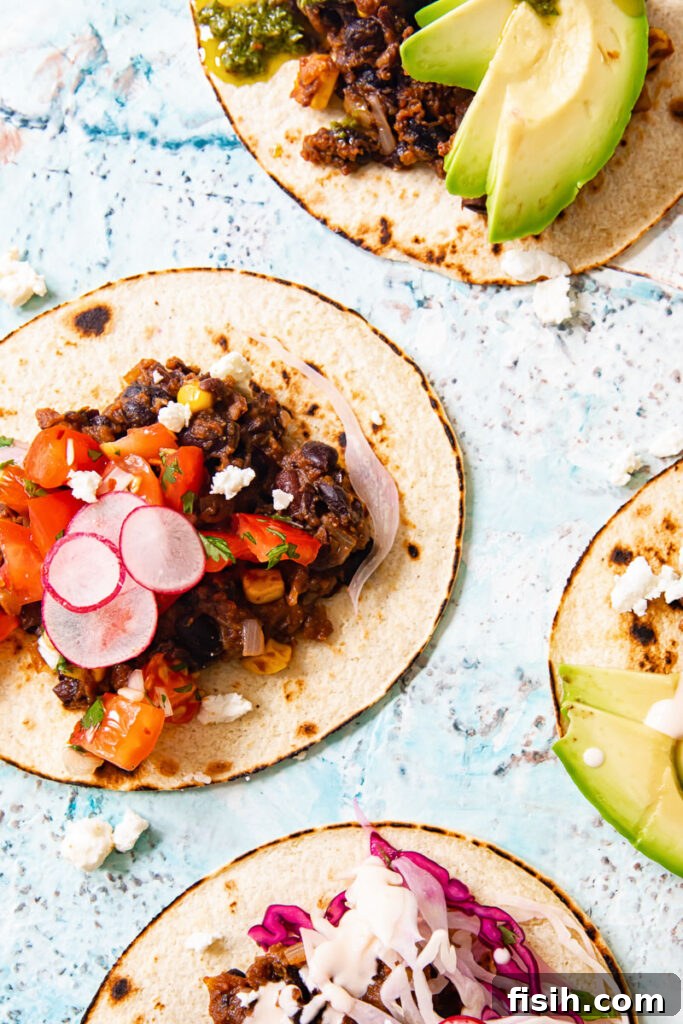 Black Bean Corn Tacos Topped with Zesty Cilantro Lime Slaw 5 Black bean tacos with toppings including avocado, slaw and radishes