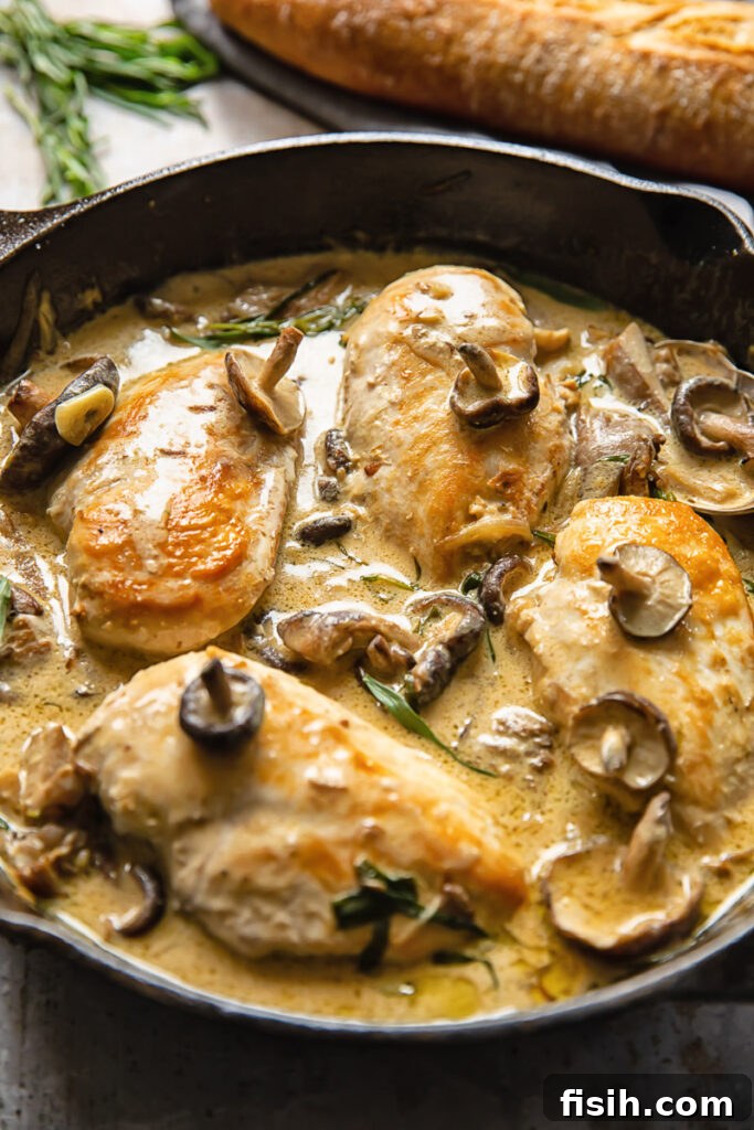 Side shot chicken breasts in forestiere sauce topped with mushrooms in a deep pan