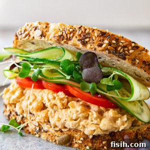 Angled view of chickpea salad sandwich on a plate