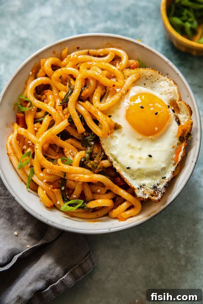 Kimchi Noodles in Minutes 2 A beautifully plated bowl of kimchi noodles, topped with a perfectly fried egg and garnished with fresh green onions