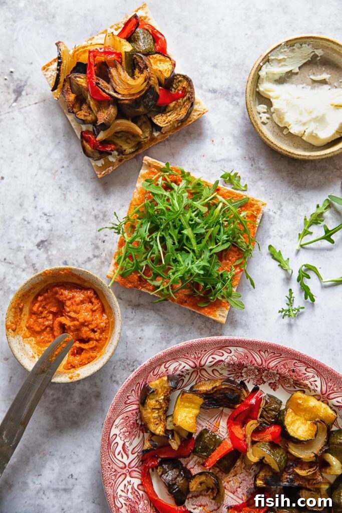 Harvest Roasted Vegetable and Creamy Chevre Sandwich 3 An inviting overhead table setting showing the assembly process of the Roasted Vegetable and Goat Cheese Sandwich, with ingredients artfully arranged.