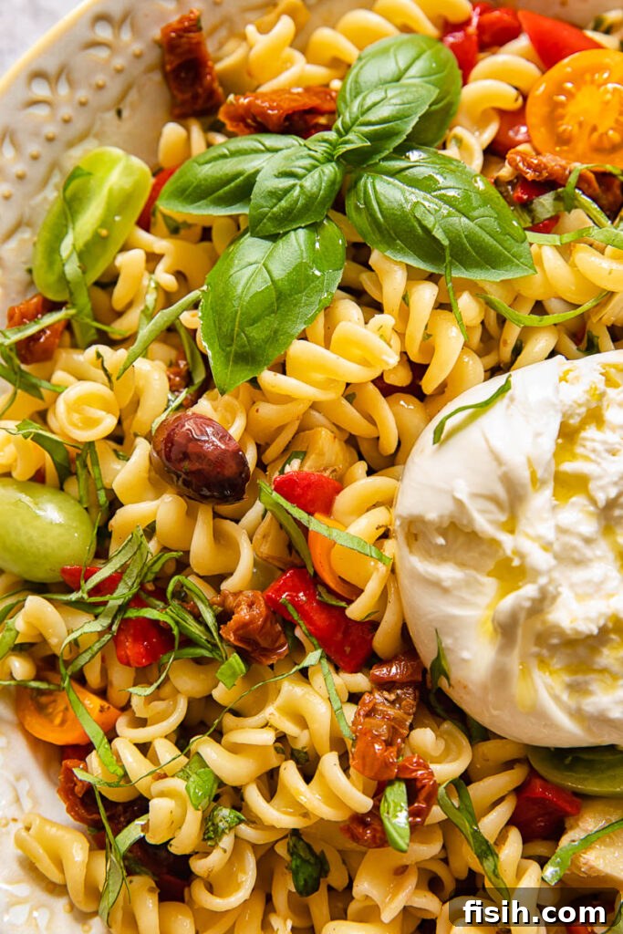 Close up of pasta salad with a ball of burrata