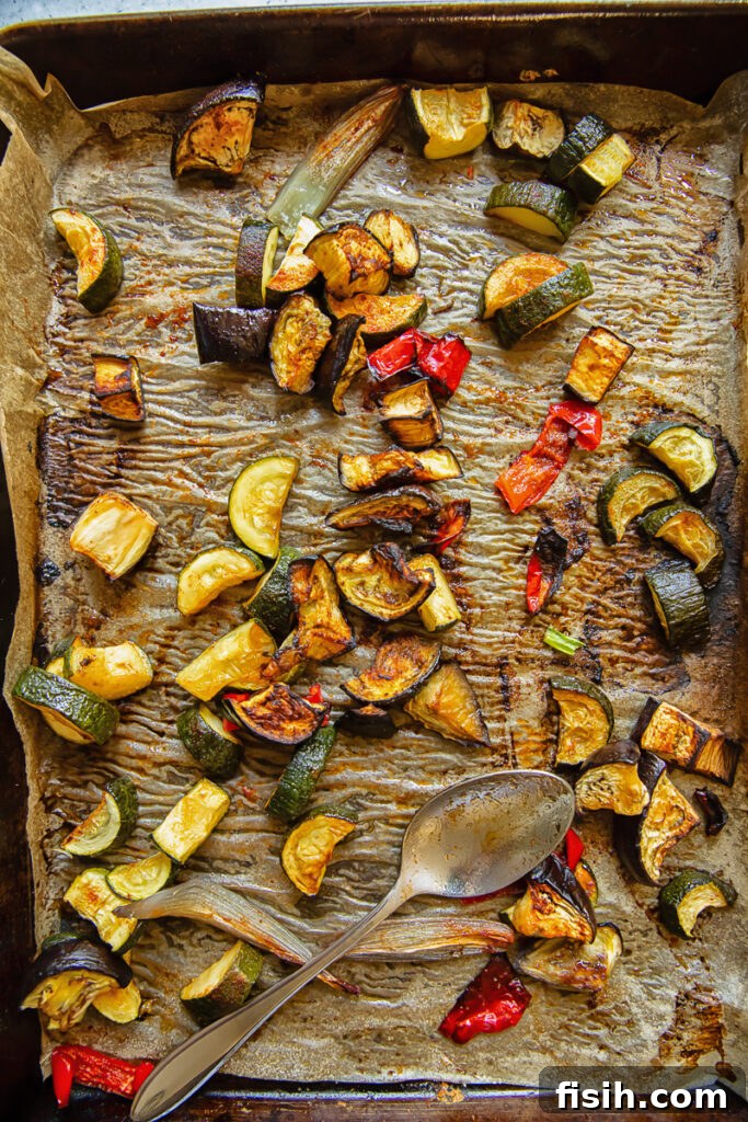 Summer's Bounty Roasted Salad with Savory Seed Crunch 4 Top down shot of chopped up peppers, eggplant and zucchini roasted on a baking tray