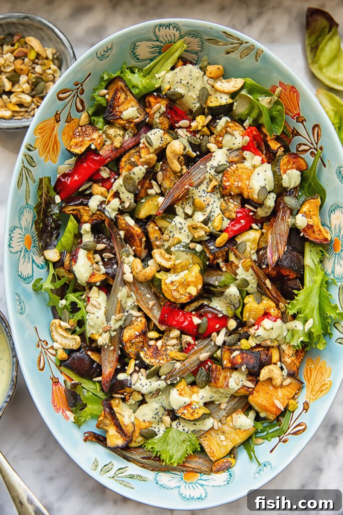 Summer's Bounty Roasted Salad with Savory Seed Crunch 5 Top down shot of roasted veg salad in a large serving dish topped with nuts and tahini dressing