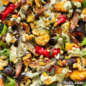 Summer's Bounty Roasted Salad with Savory Seed Crunch 6 Close up shot of roasted zucchini, pepper and eggplant topped with nuts and tahini dressing