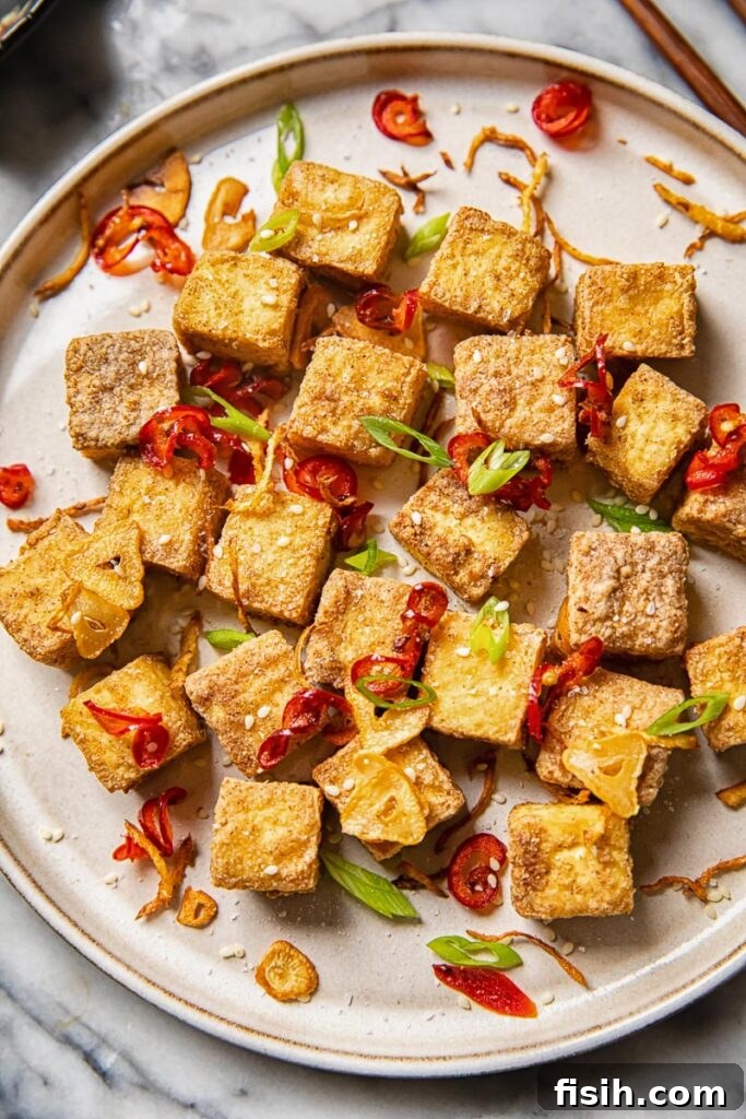 Air fryer tofu bites on a plate with peppers and garlic
