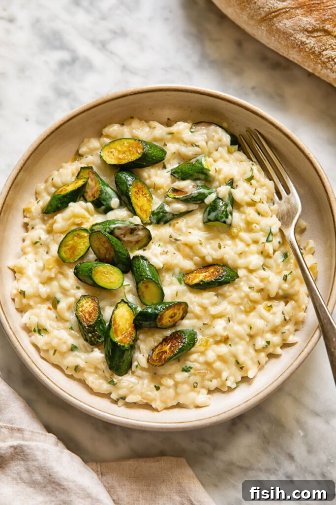 Creamy Instant Pot Zucchini Risotto with Garlic-Herb Boursin 4 top down shot of a fork in a bowl of boursin risotto with zucchini