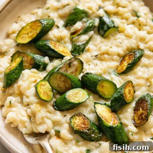 Creamy Instant Pot Zucchini Risotto with Garlic-Herb Boursin 6 Close up shot of creamy boursin risotto in a bowl, topped with zucchini