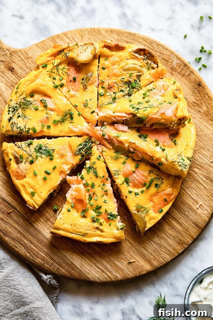Savory Smoked Salmon and Dill Frittata 2 Top down shot of salmon frittata slices on a platter topped with herbs
