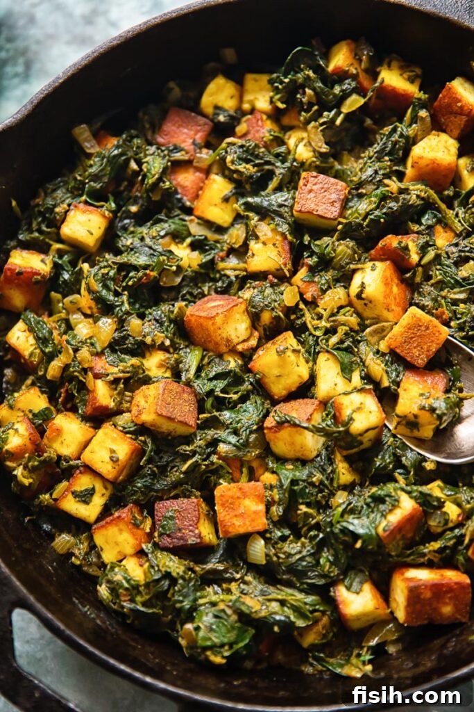 Top down view of saag paneer in a cast iron pan