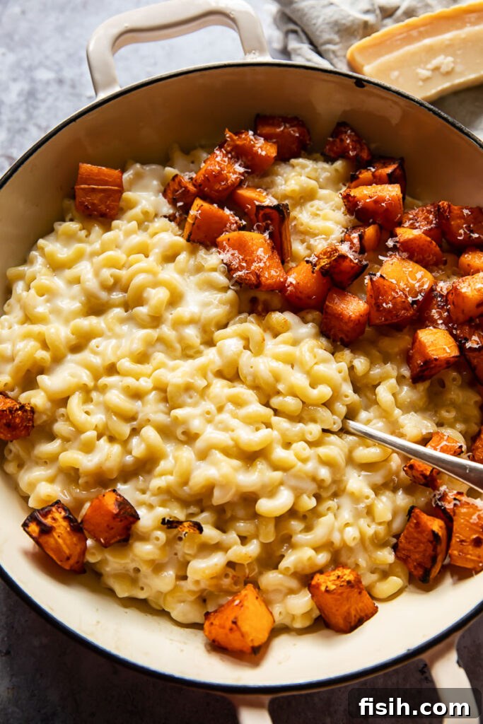Overhead view of butternut squash macaroni and cheese in a pan, ready to serve
