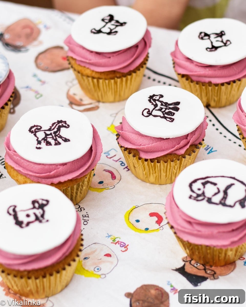 Wild Rumpus Party Cupcakes 2 Top down view of pink icing cupcakes with animal designs