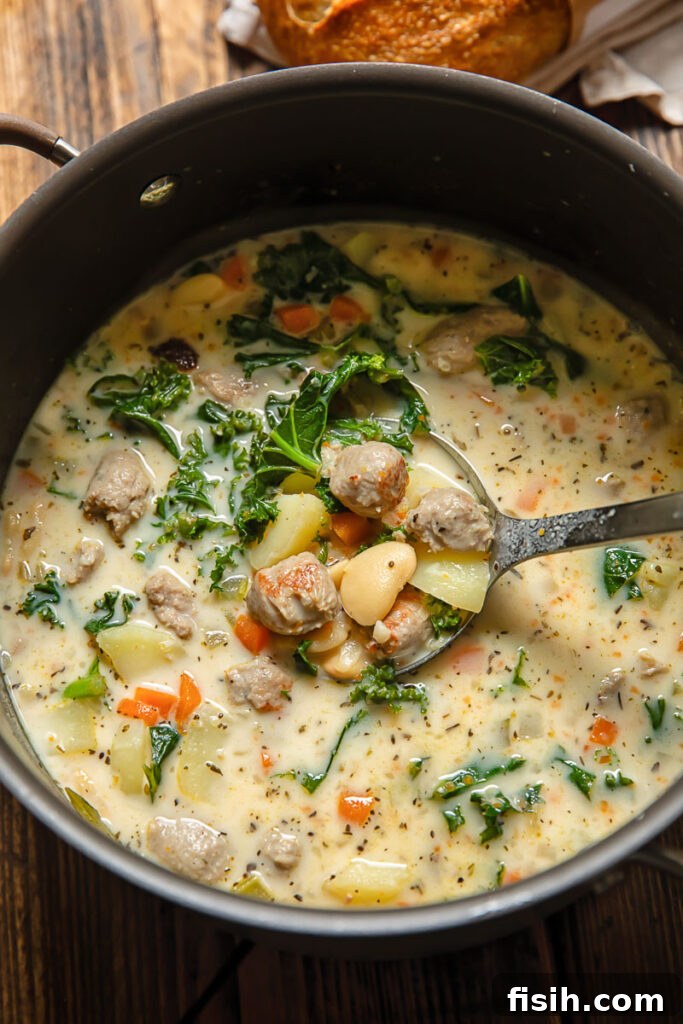 Rustic Sausage and White Bean Comfort 3 Top down shot of white bean and sausage soup with creamy broth in a large pot