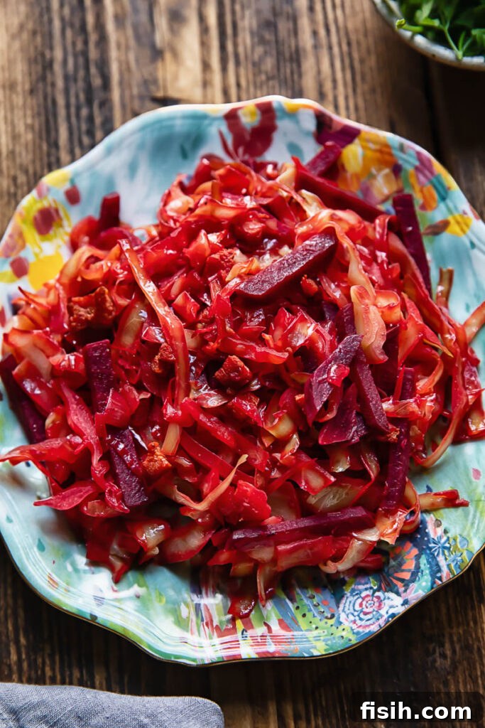 Top down shot of a large serving of braised cabbage and beets on a small blue plate