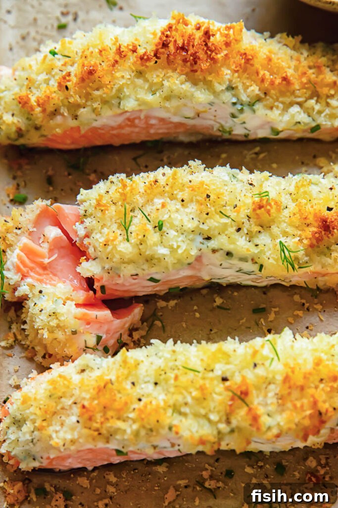 Close up shot of three salmon fillets on a baking sheet