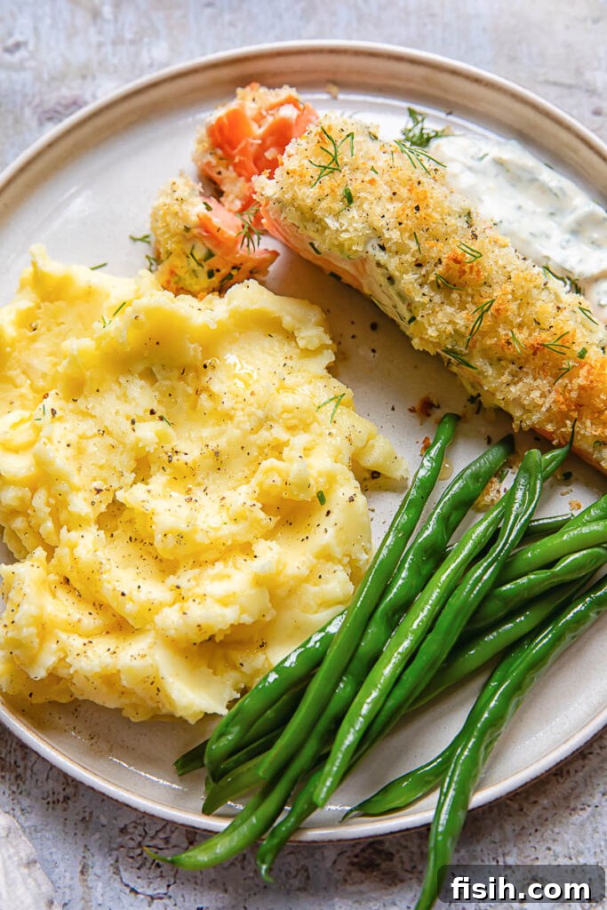 Top down shot of a salmon fillet baked with garlic and panko