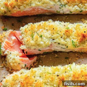 Close up shot of three salmon fillets on a baking sheet