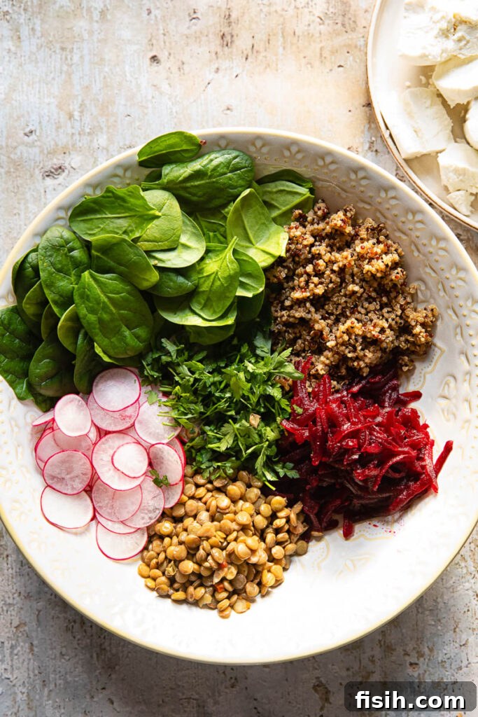 Beet and Lentil Quinoa Power Salad 3 Process shot of quinoa and lentil salad ingredients being combined in a large bowl.