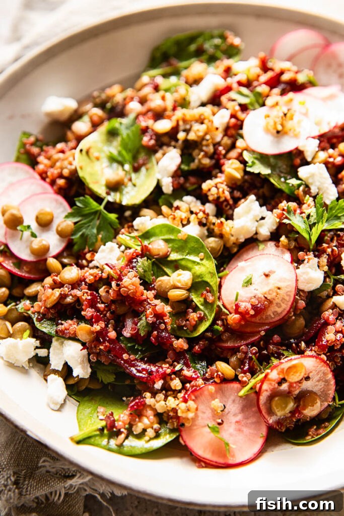 Beet and Lentil Quinoa Power Salad 6 Side shot of quinoa salad with lentils and beets in an elegant white bowl, ready for serving.