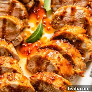 Top down shot of molasses glazed pork tenderloin slices on a plate