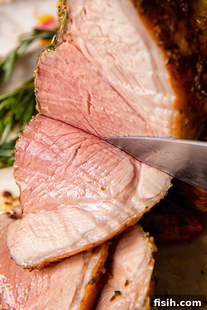 Herbed Roast Lamb Leg with Zesty Mint Drizzle 2 side view of roast lamb being sliced
